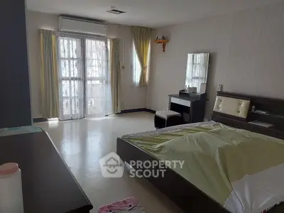 Spacious bedroom with natural light and modern furnishings