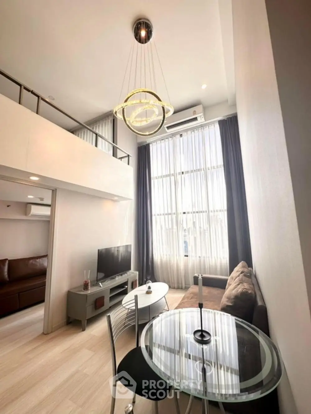 Modern loft-style living room with high ceilings and elegant decor