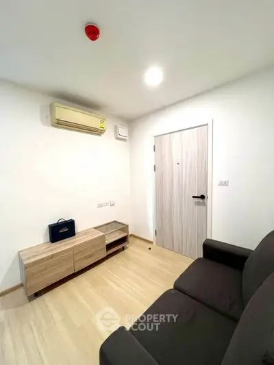 Modern living room with sleek furniture and air conditioning