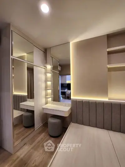 Modern bedroom with mirrored wardrobe and ambient lighting