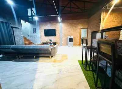 Spacious modern living room with stylish decor and exposed brick walls