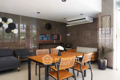 Modern living room with stylish furniture and air conditioning, featuring elegant decor and natural light.