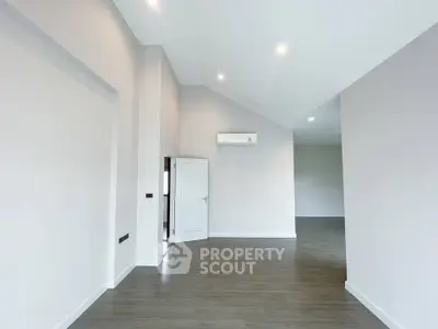 Spacious modern interior with high ceilings and sleek flooring, perfect for customization.