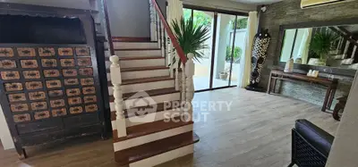 Charming interior with wooden staircase and stylish decor in a cozy living space.