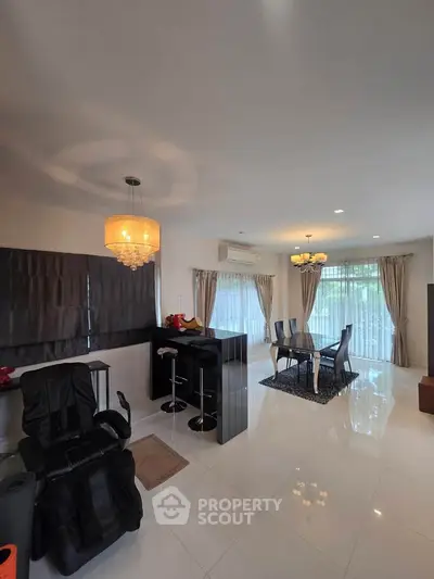 Spacious modern living room with elegant dining area and large windows for natural light.