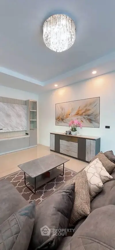 Luxurious living room with elegant decor and modern chandelier