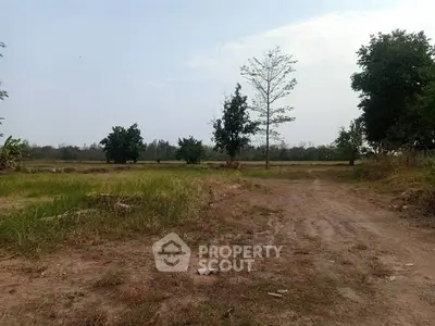 Expansive plot of land with lush greenery and clear skies, perfect for development opportunities.