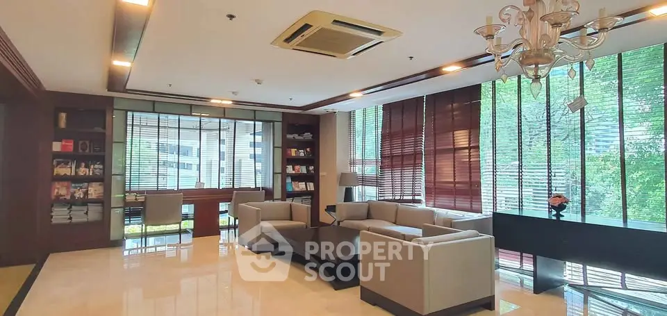Luxurious living room with elegant seating and large windows offering natural light and garden views.