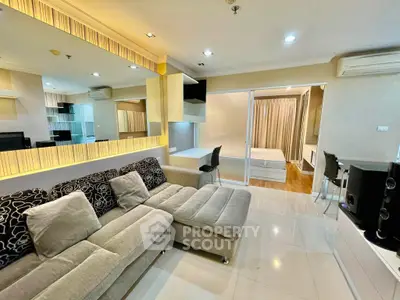 Modern open-plan living room with stylish decor and cozy seating area in a contemporary apartment.