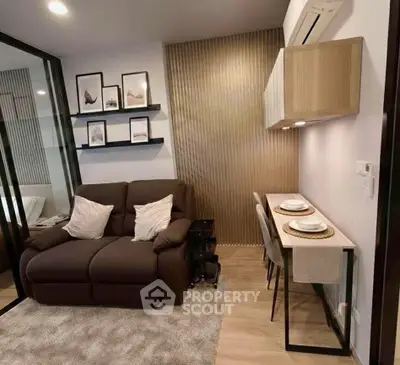 Modern living room with cozy sofa and stylish dining area in a compact apartment.