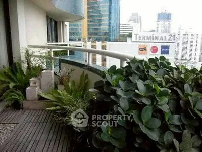Luxurious urban balcony with lush greenery and cityscape view