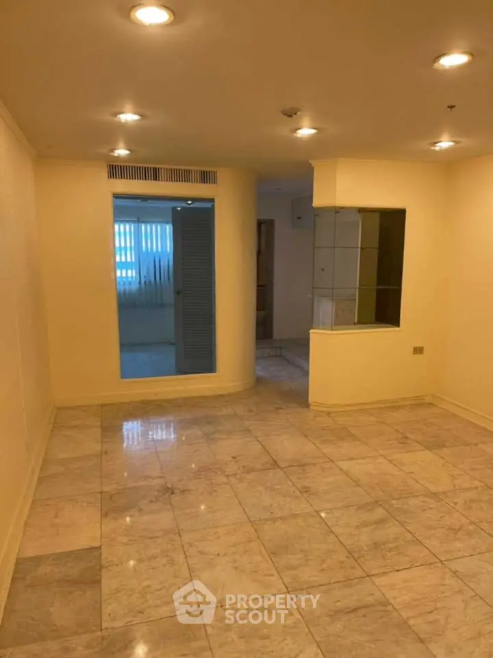 Spacious interior with marble flooring and recessed lighting, ideal for modern living.
