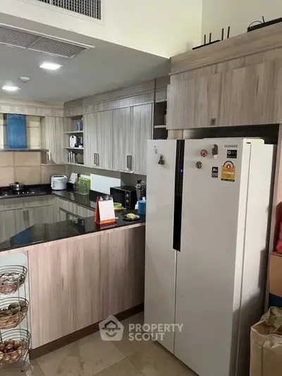Modern kitchen with sleek cabinetry and spacious refrigerator