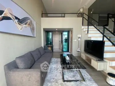Modern duplex living room with stylish decor and open staircase