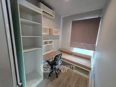 Modern study room with built-in desk, shelves, and cozy seating area.