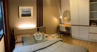 Cozy bedroom with modern decor, featuring a comfortable bed, stylish desk, and ample storage space.