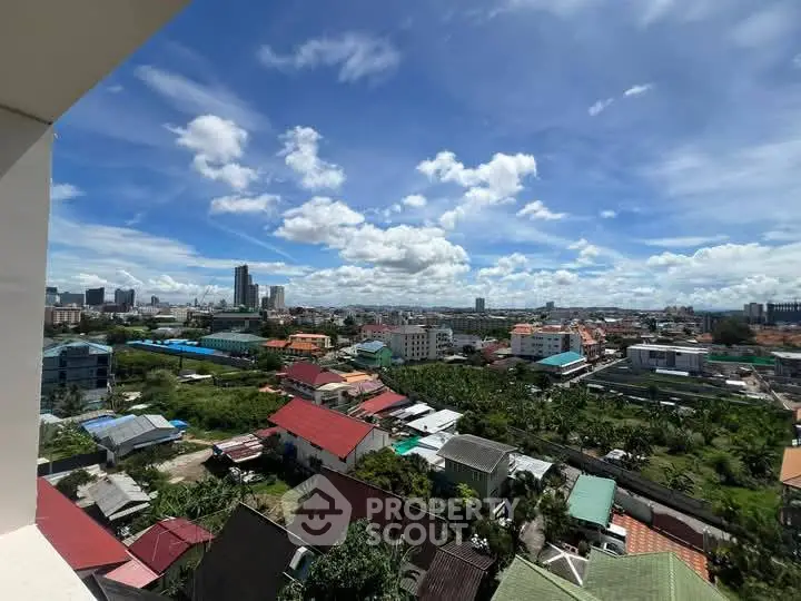 Stunning cityscape view from high-rise balcony with vibrant skyline and clear blue skies.