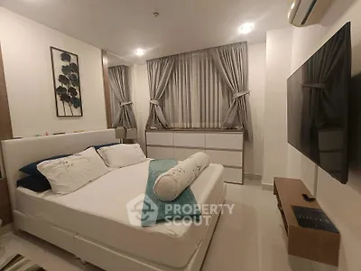 Modern bedroom with sleek design, featuring a comfortable bed, stylish curtains, and a wall-mounted TV.