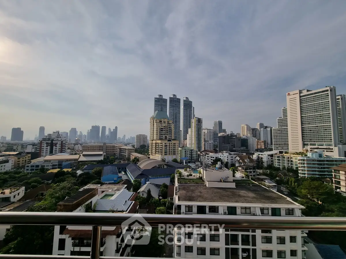 Stunning cityscape view from a high-rise balcony showcasing urban skyline and modern architecture.