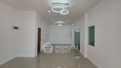 Spacious modern living room with elegant lighting and glossy tiled floors