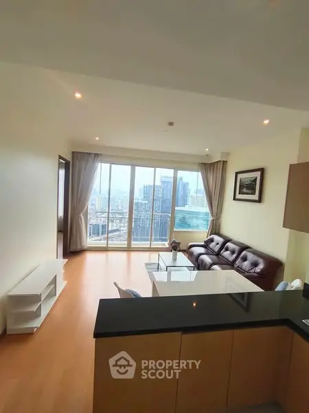 Spacious living room with city view and modern furnishings