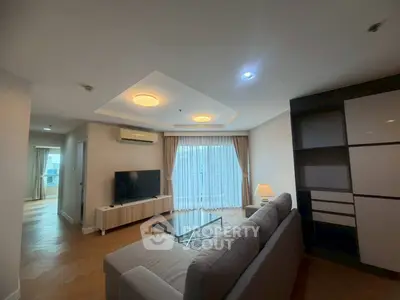 Spacious modern living room with elegant decor and large windows in a stylish apartment.