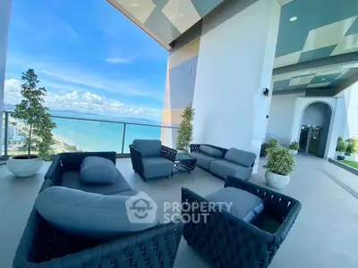 Luxurious balcony with stunning ocean view and modern outdoor seating