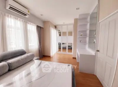 Spacious bedroom with modern design and ample natural light