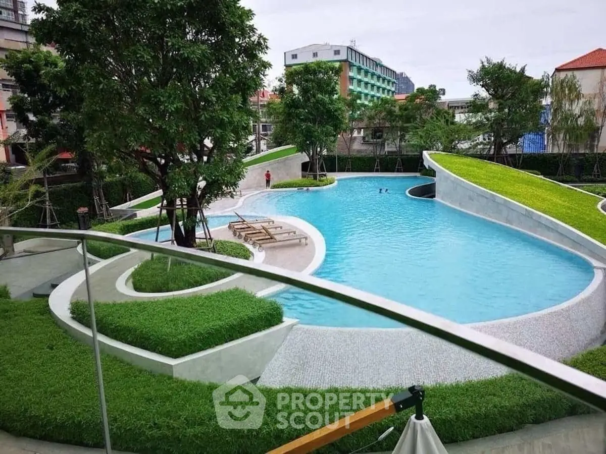 Luxurious outdoor pool with lush greenery and modern design.
