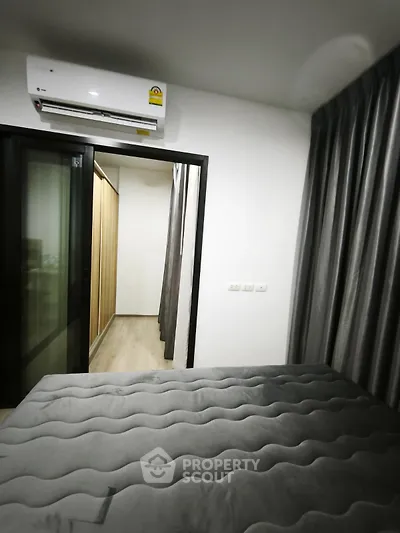Modern bedroom with sleek design and air conditioning in a stylish apartment.