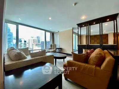 Spacious living room with city view, modern furniture, and large windows in a high-rise apartment.
