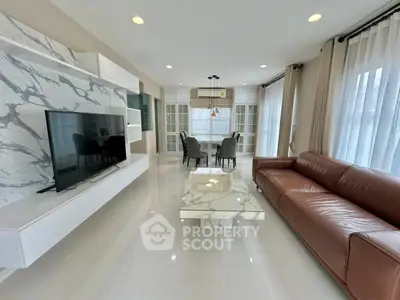 Spacious modern living room with marble accents and leather sofa, perfect for stylish entertaining.