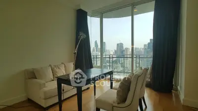 Modern living room with city view, featuring elegant furniture and floor-to-ceiling windows.