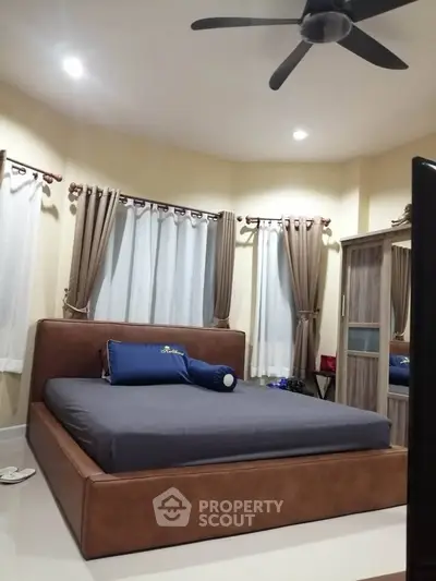 Spacious bedroom with modern decor and large windows