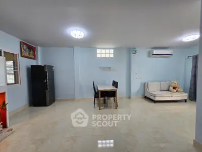 Spacious living room with modern decor and ample natural light