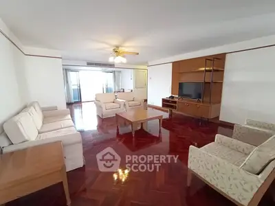 Spacious living room with elegant wooden flooring and cozy seating area.