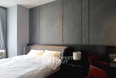 Modern bedroom with sleek design and stylish furniture, featuring a comfortable bed and elegant decor.