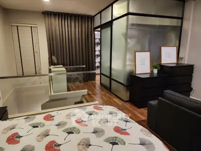 Stylish modern bedroom with frosted glass partition and chic decor