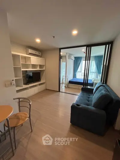 Modern living room with open layout and cozy furnishings in a stylish apartment.
