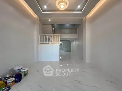 Spacious modern interior with high ceilings and elegant lighting, perfect for stylish living.
