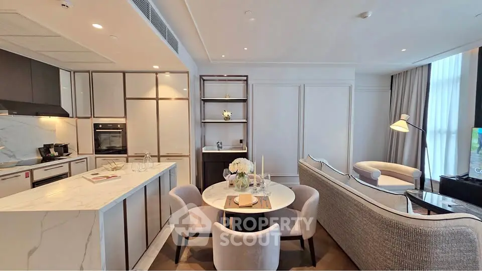 Luxurious open-plan living room and kitchen with elegant decor and modern appliances.