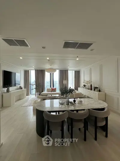 Luxurious open-plan living room with elegant dining area and panoramic city views.