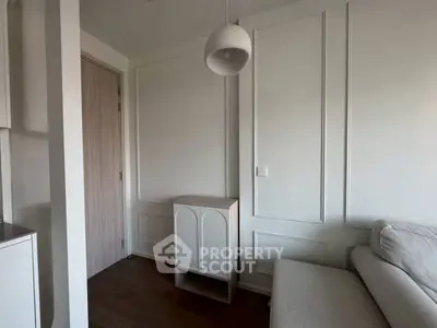 Modern minimalist living room with elegant paneling and stylish lighting