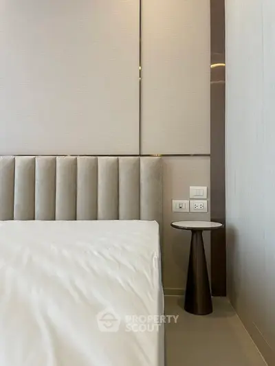 Modern bedroom with elegant headboard and stylish side table