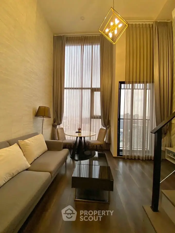 Luxurious high-ceiling living room with elegant decor and stunning city view.