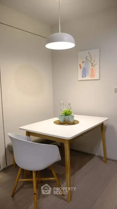 Cozy dining nook with modern table and chair, perfect for intimate meals.