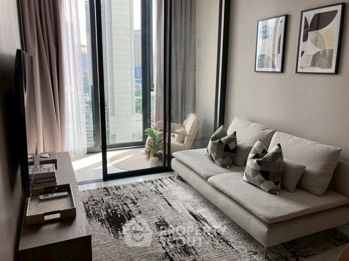 Modern living room with balcony view, stylish decor, and natural light in urban apartment.