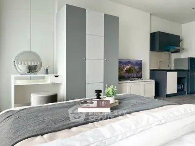 Modern bedroom with sleek decor and compact kitchen area, ideal for urban living.