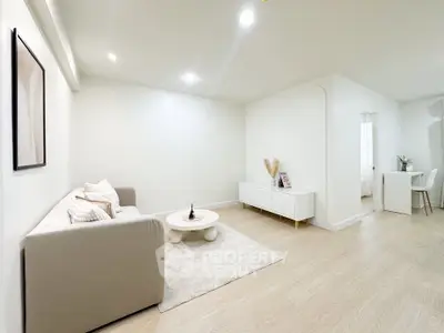 Spacious modern living room with minimalist decor and cozy seating area.