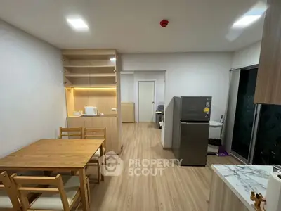 Modern kitchen with wooden dining set and stainless steel fridge in open layout